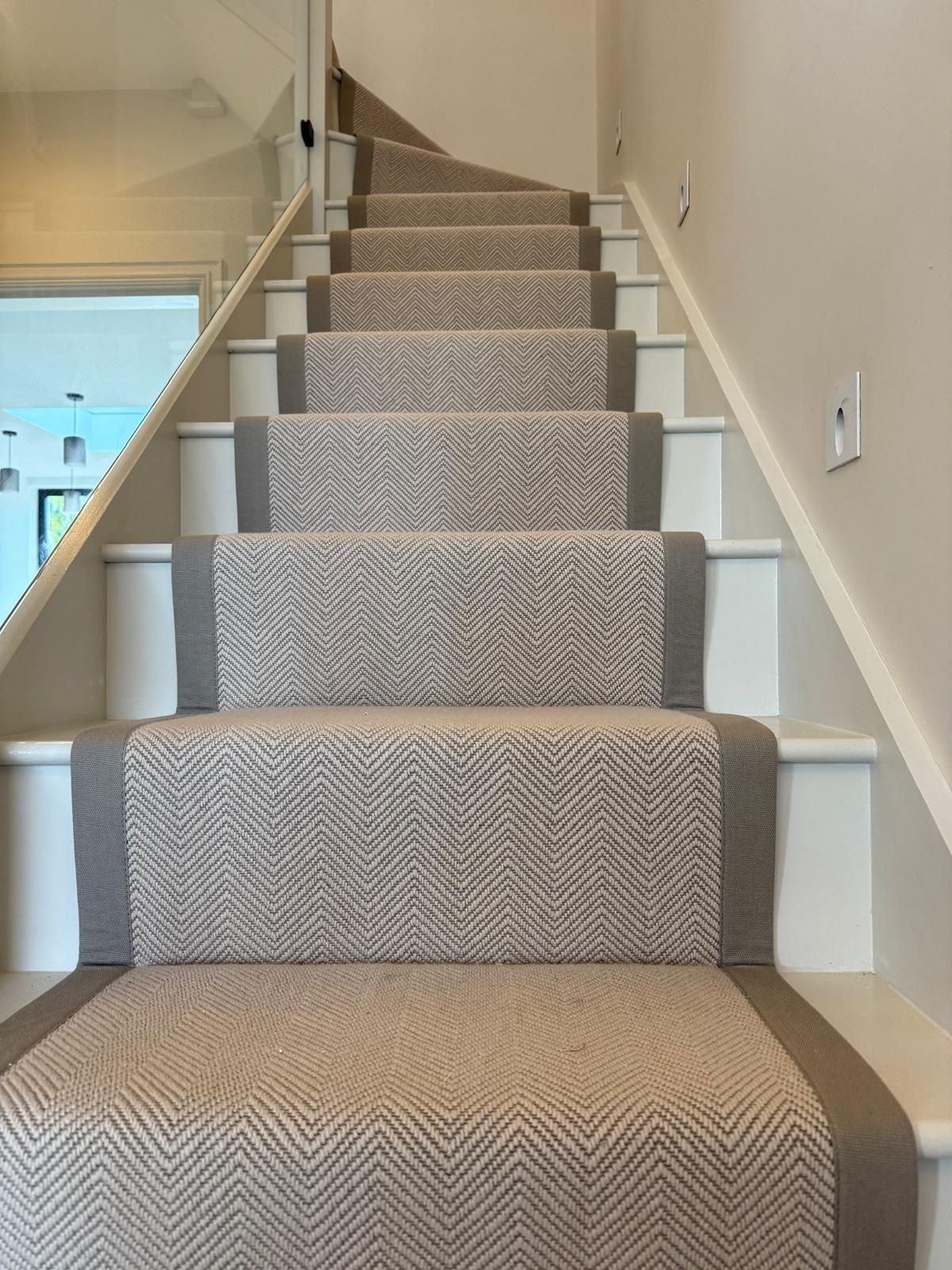 A bespoke flat-weave wool runner fitted over a turning staircase.