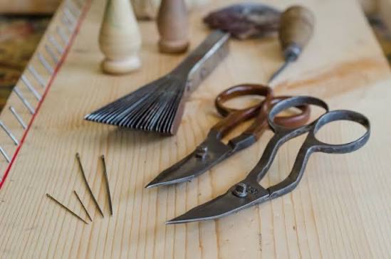 Traditional carpet shears, tacks and hand tools on a workbench
