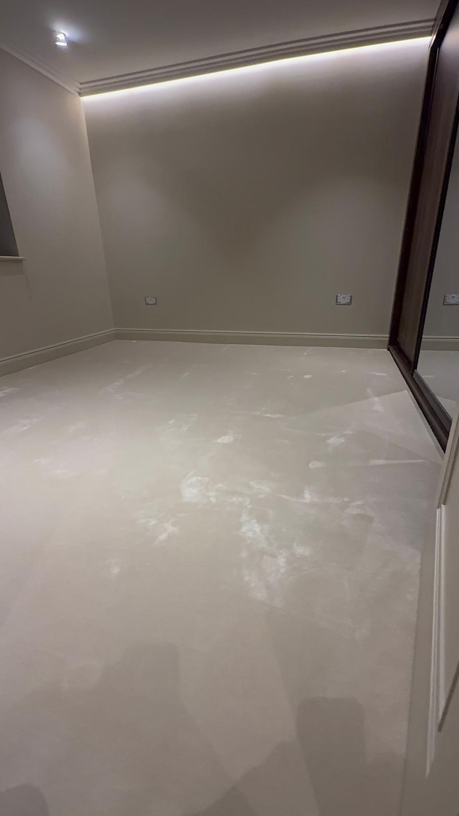 Cream carpet in a bedroom lit by concealed cove lighting